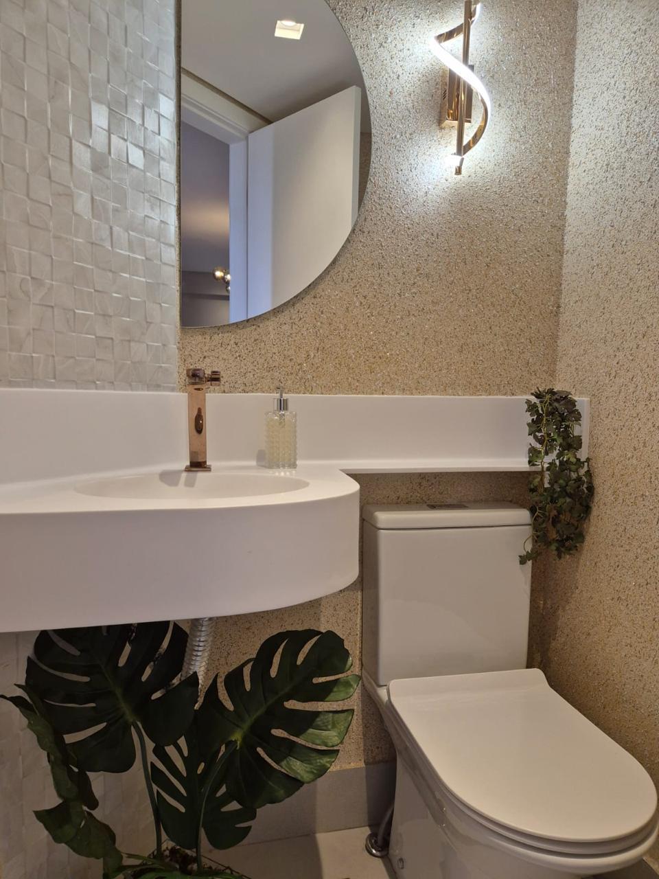 Lavabo com espelho redondo e bancada em Corian®
